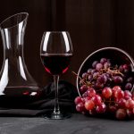 Decantador de vino con copa de vino y uvas